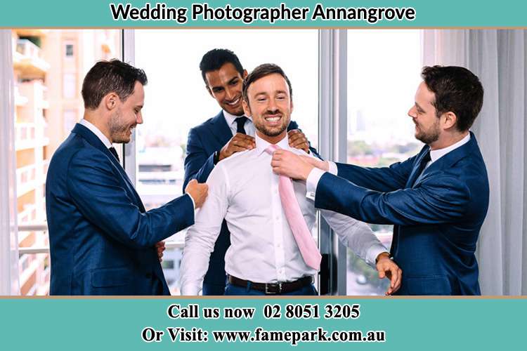 Photo of the Groom being help by the groomsmen to get ready Annangrove NSW 2156