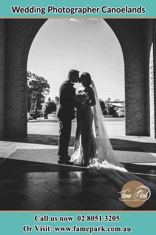 Photo of the Groom and the Bride kissing at the front of the church Canoelands NSW 2157