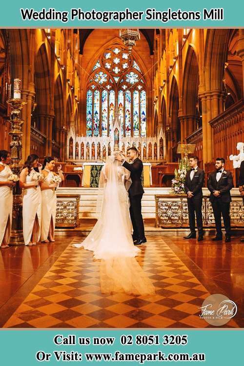 Photo of the Bride and the Groom at the altar Singletons Mill NSW 2775